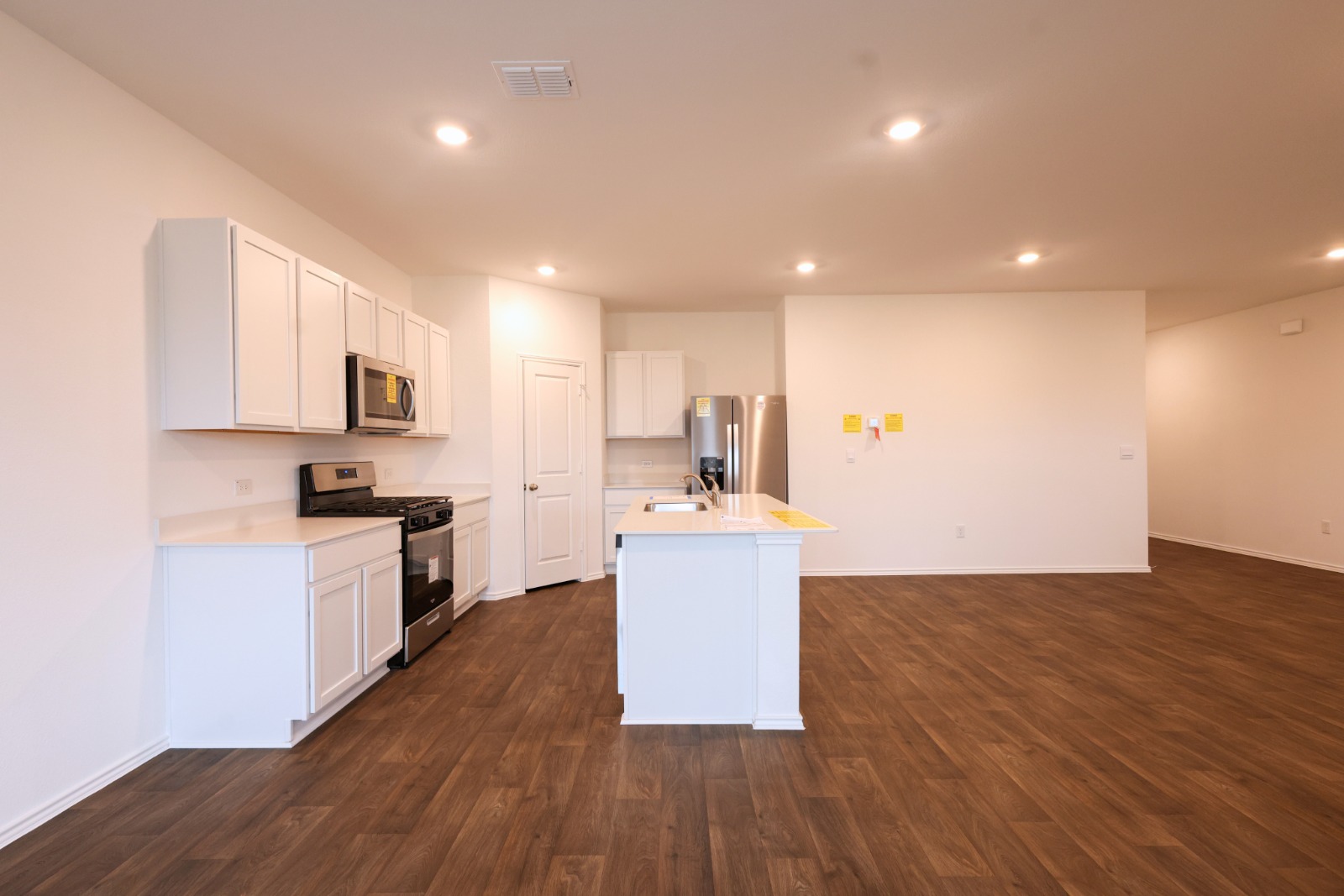 12306 Bulldogger Bend Buda, TX 78610 - Photo 4 of 11 a kitchen with a sink and steel appliances