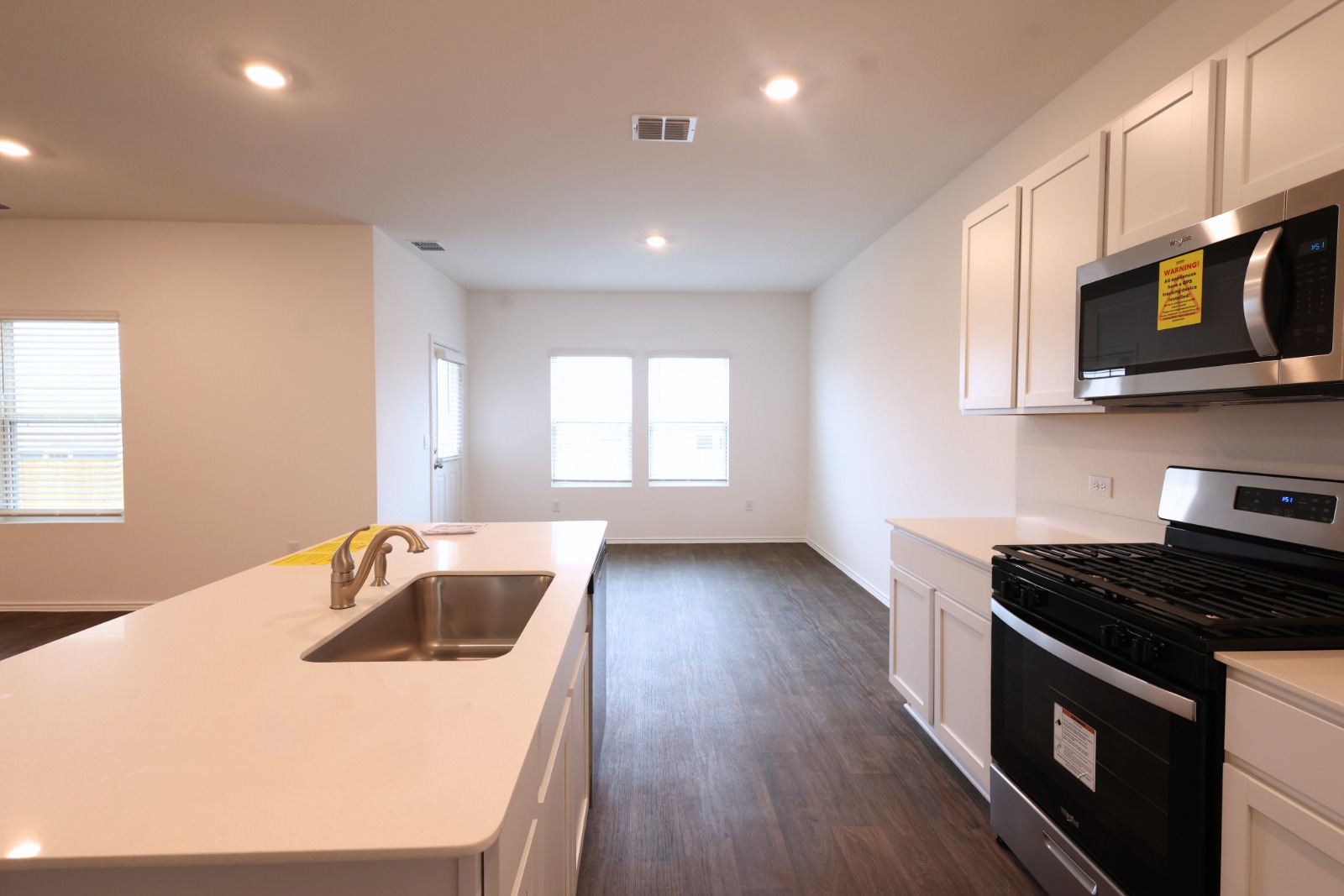 12306 Bulldogger Bend Buda, TX 78610 - Photo 5 of 11 a kitchen that has a sink and a stove top oven