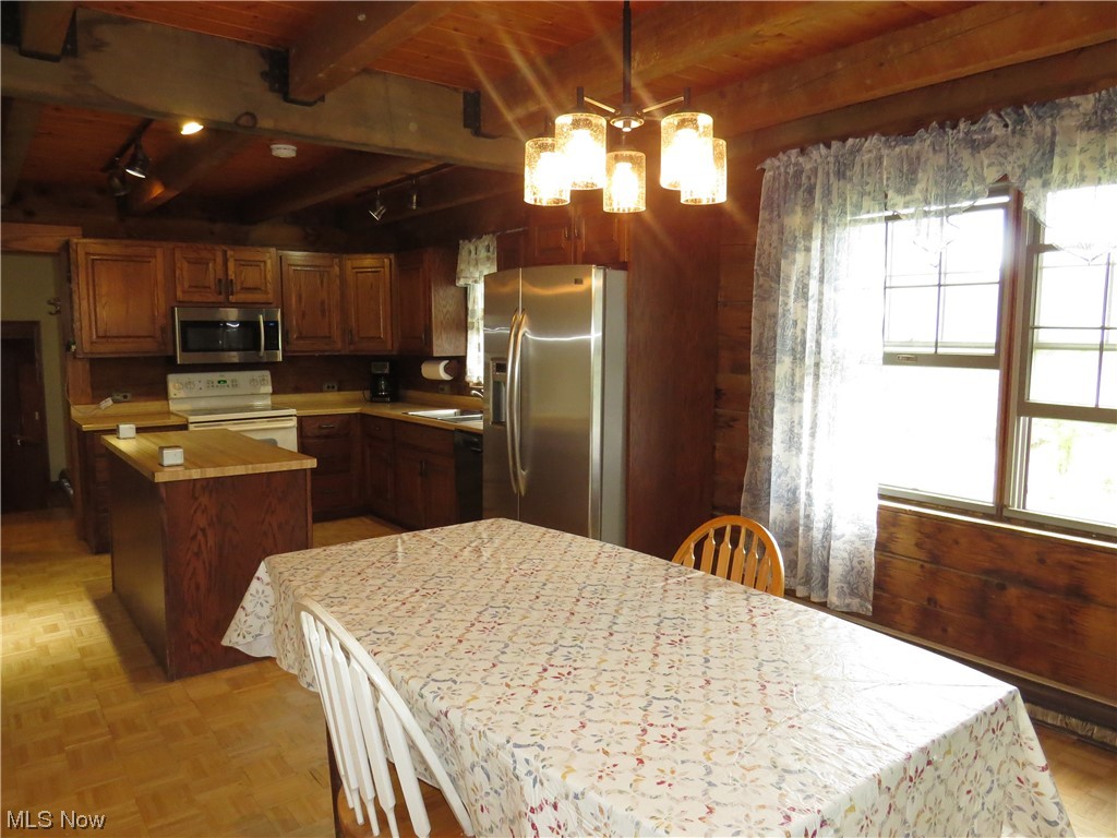 9797 Thwing Road Chardon, OH 44024 - Photo 11 of 35 Kitchen featuring light parquet floors, wooden ceiling, a kitchen island, hanging light fixtures, and appliances with stainless steel finishes