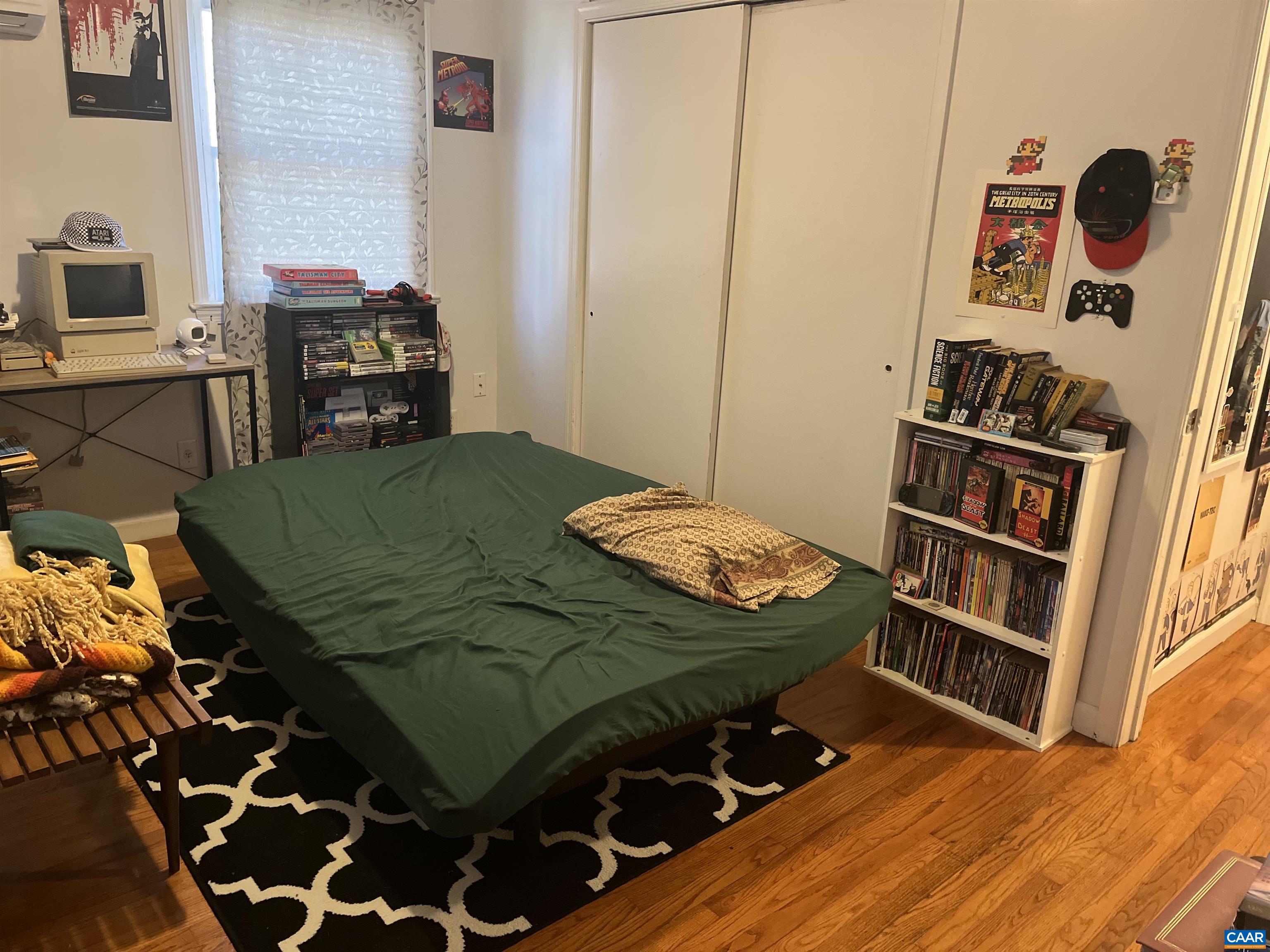 158 Buckingham Circle, Unit A&B Charlottesville, VA 22903 - Photo 15 of 23 a bedroom with a bed and a book shelf