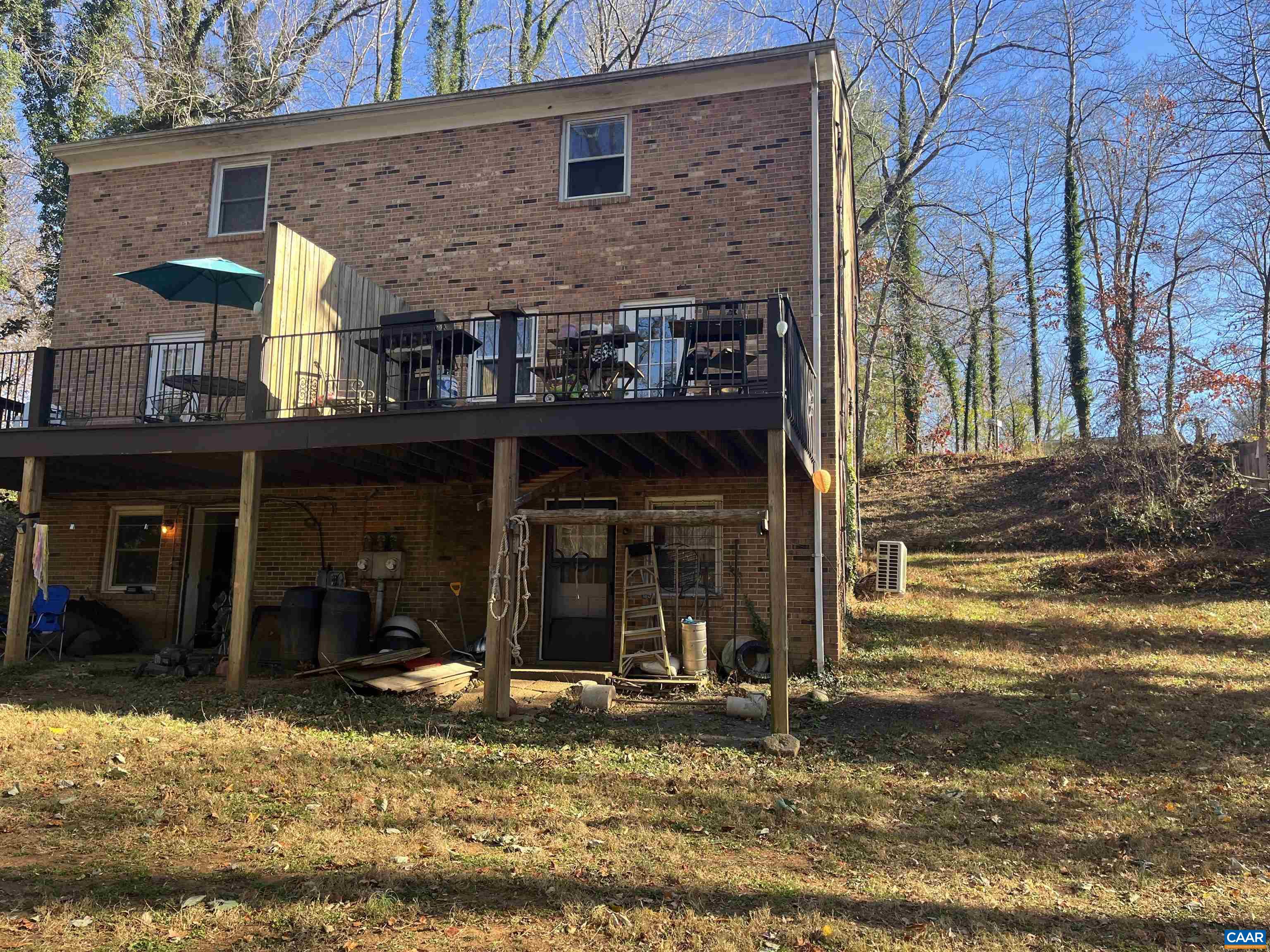 158 Buckingham Circle, Unit A&B Charlottesville, VA 22903 - Photo 3 of 23 a view of a brick house with large windows and a small yard