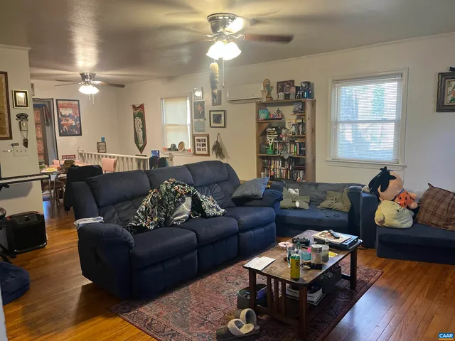 a living room with furniture fireplace and a window