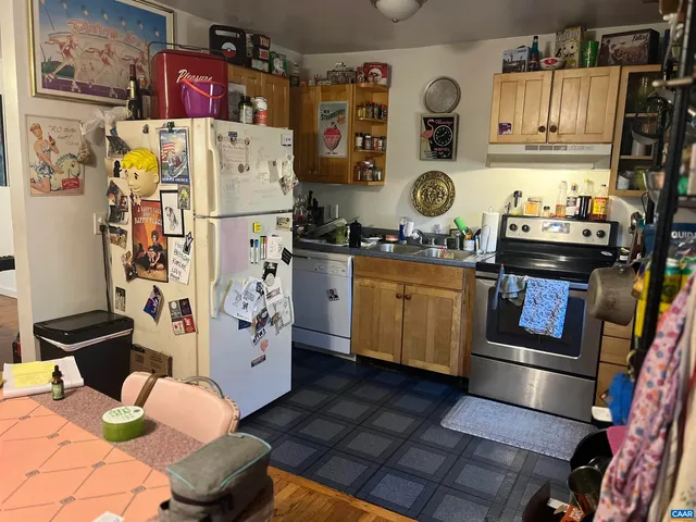 a kitchen with stainless steel appliances granite countertop a refrigerator and a stove