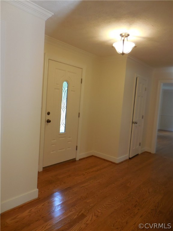 15206 Harrowgate Road Chester, VA 23831 - Photo 3 of 19 an empty room with wooden floor and mirror