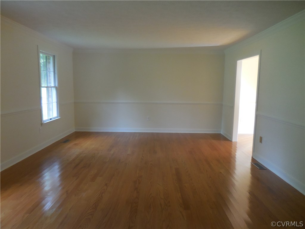 15206 Harrowgate Road Chester, VA 23831 - Photo 4 of 19 an empty room with wooden floor and windows