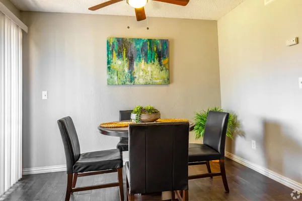 a view of a dining room with furniture a fireplace and wooden floor