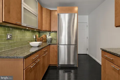 a kitchen with stainless steel appliances granite countertop a sink and a stove