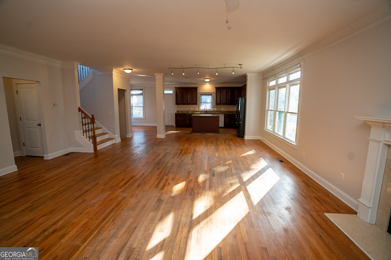 901 Custer Avenue Southeast Atlanta, GA 30315 - Photo 20 of 21 a view of open kitchen with wooden floor and a fireplace