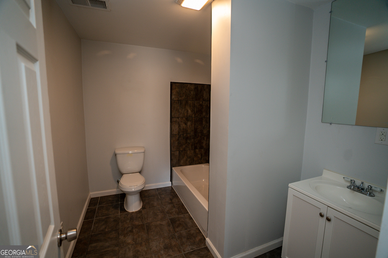 901 Custer Avenue Southeast Atlanta, GA 30315 - Photo 5 of 21 a bathroom with a toilet and a sink