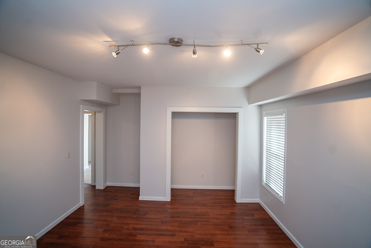 901 Custer Avenue Southeast Atlanta, GA 30315 - Photo 8 of 21 an empty room with wooden floor and windows