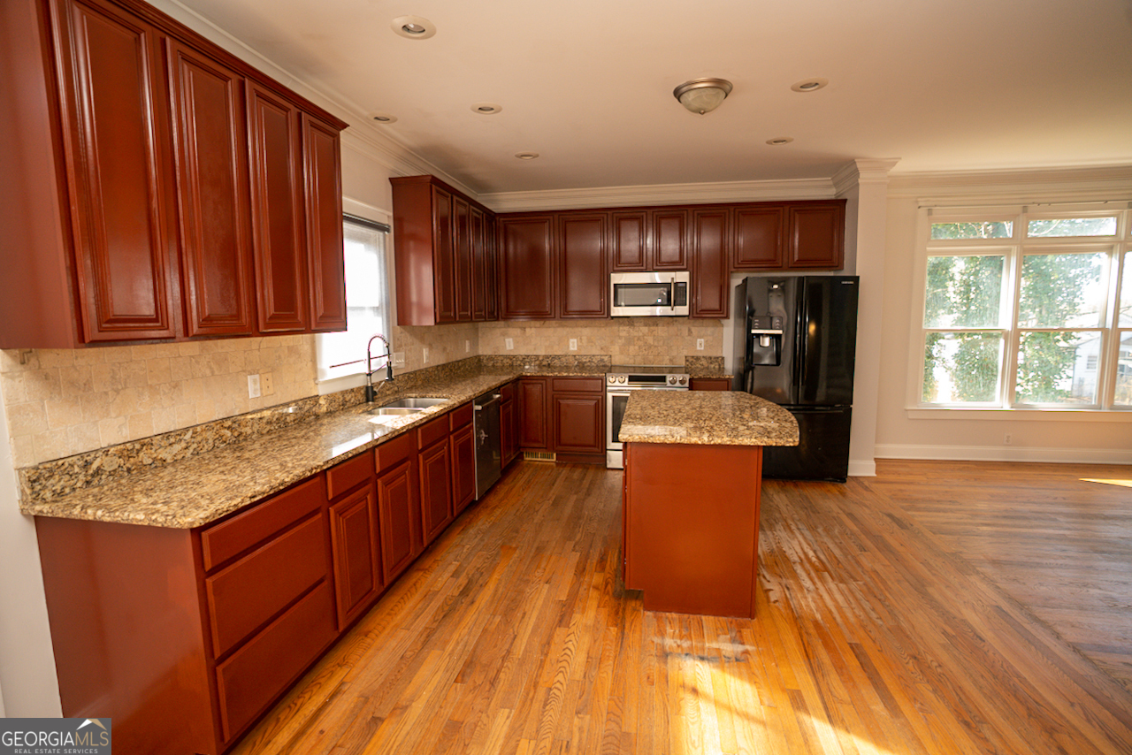 901 Custer Avenue Southeast Atlanta, GA 30315 - Photo 10 of 21 a large kitchen with stainless steel appliances granite countertop wooden cabinets a stove a sink and a large window
