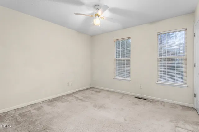 a view of empty room with ceiling fan