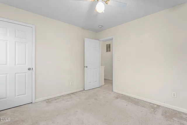 an empty room with a ceiling fan