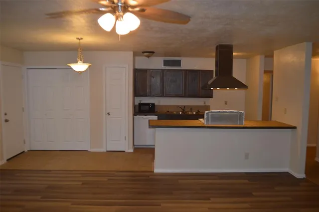 a kitchen with a sink cabinets and wooden floor