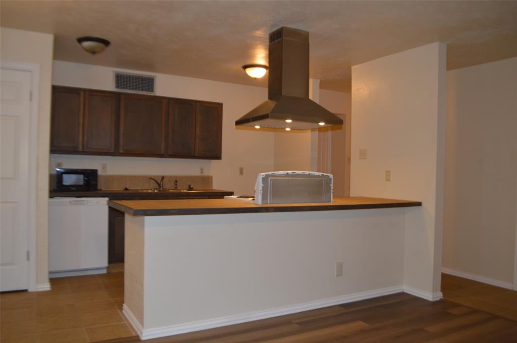 5329 Strickland Avenue The Colony, TX 75056 - Photo 6 of 6 a kitchen with stainless steel appliances granite countertop a sink a stove and a refrigerator