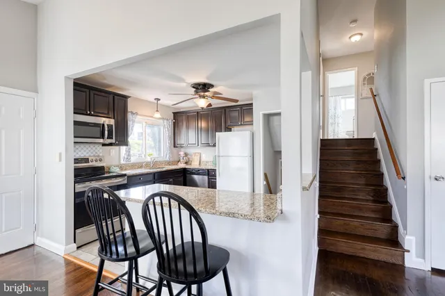 a kitchen with sink cabinets and stainless steel appliances
