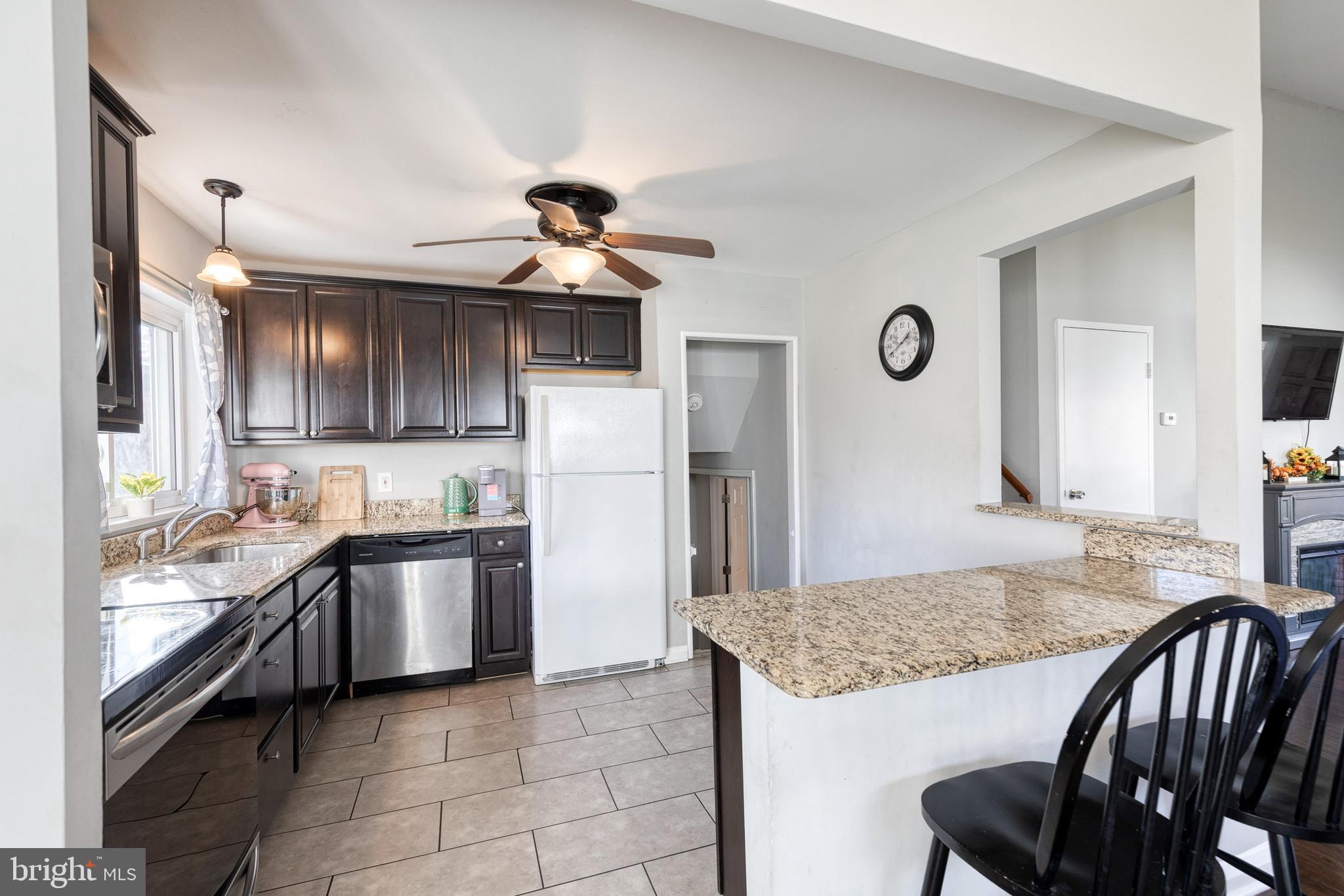 913 Marksworth Road Catonsville, MD 21228 - Photo 13 of 36 a kitchen with stainless steel appliances granite countertop a sink a stove and a refrigerator