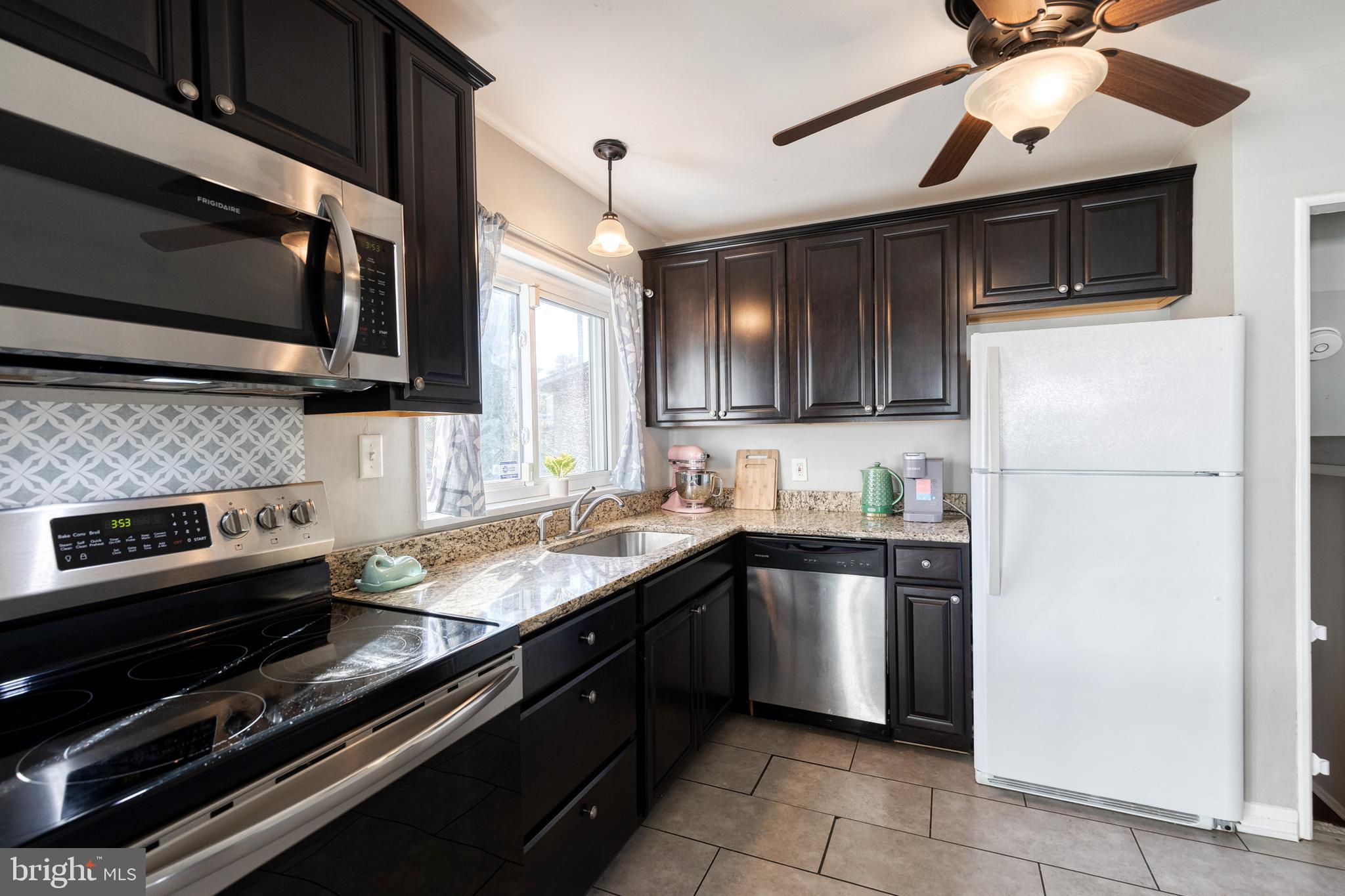 913 Marksworth Road Catonsville, MD 21228 - Photo 14 of 36 a kitchen with a sink stove and microwave