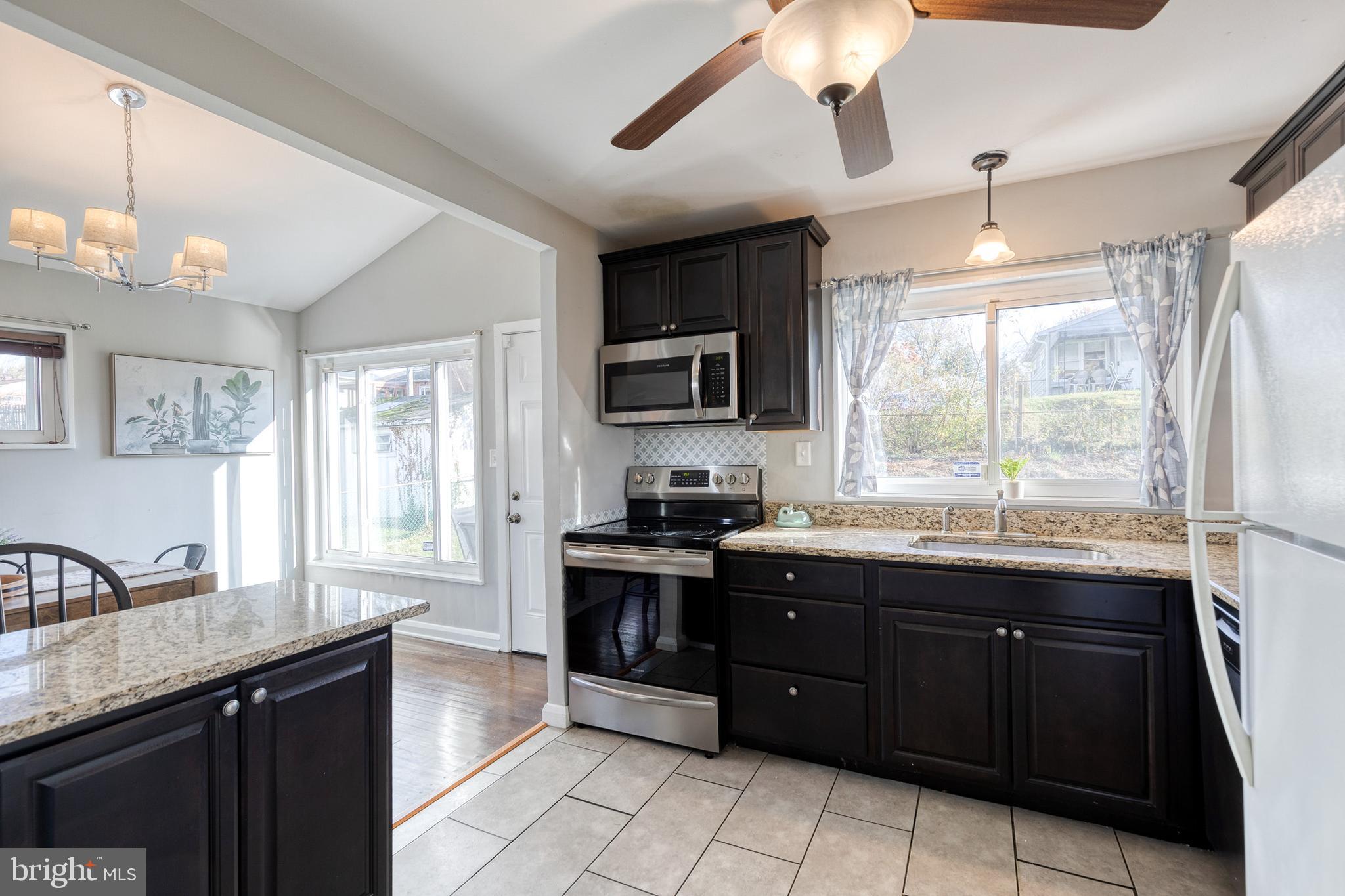 913 Marksworth Road Catonsville, MD 21228 - Photo 15 of 36 a kitchen with a sink stove and microwave