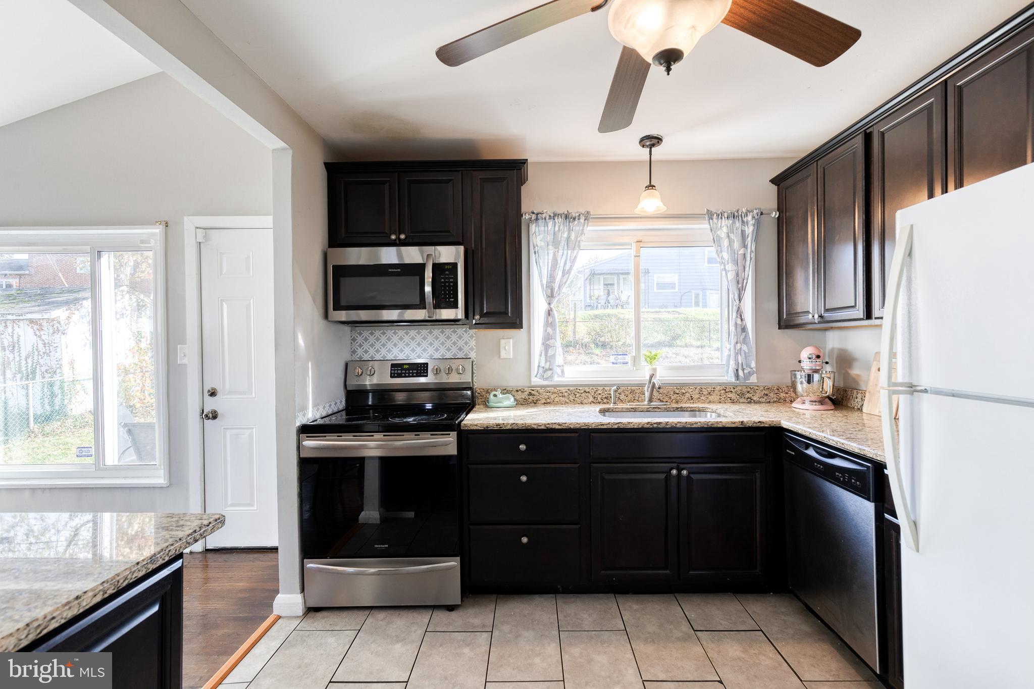 913 Marksworth Road Catonsville, MD 21228 - Photo 16 of 36 a kitchen with a sink stove and microwave