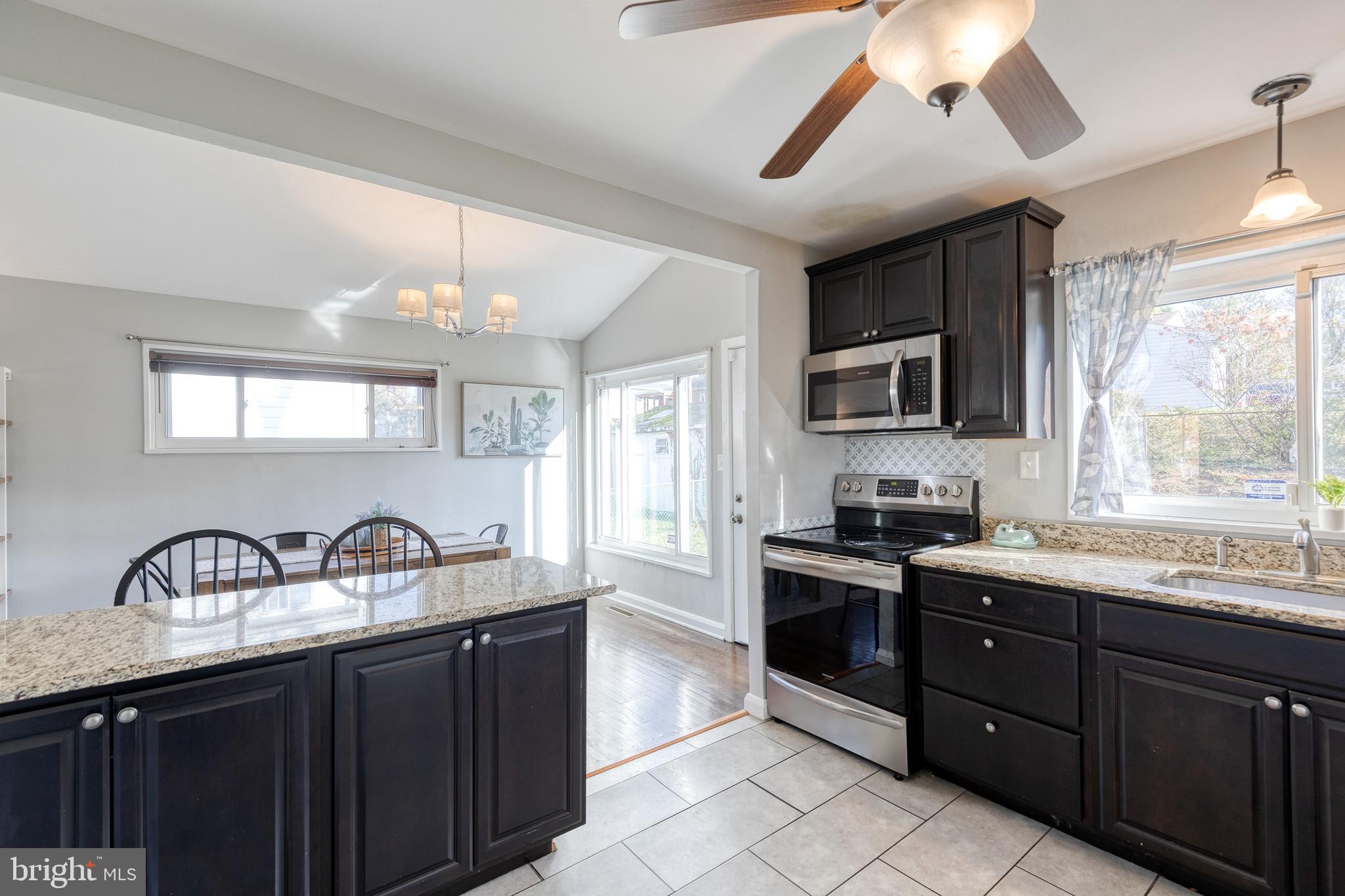 913 Marksworth Road Catonsville, MD 21228 - Photo 17 of 36 a kitchen with granite countertop a sink stainless steel appliances and cabinets