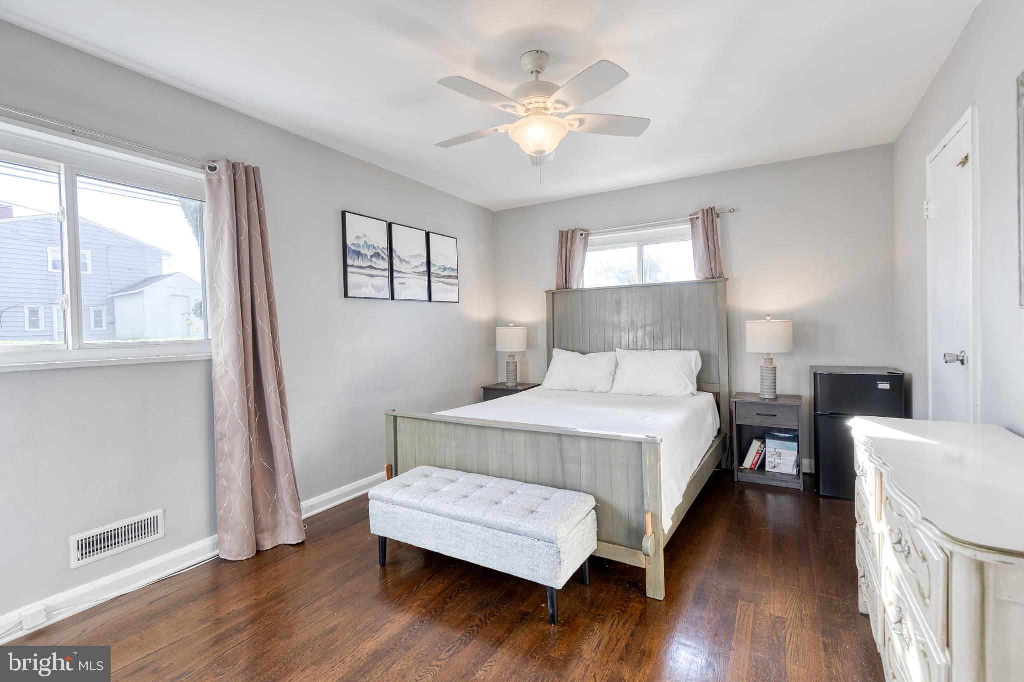 913 Marksworth Road Catonsville, MD 21228 - Photo 19 of 36 a bedroom with a bed and a large window with wooden floor