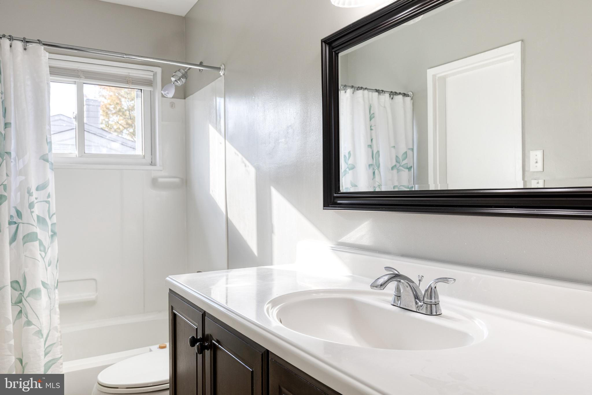 913 Marksworth Road Catonsville, MD 21228 - Photo 26 of 36 a bathroom with a sink and a mirror