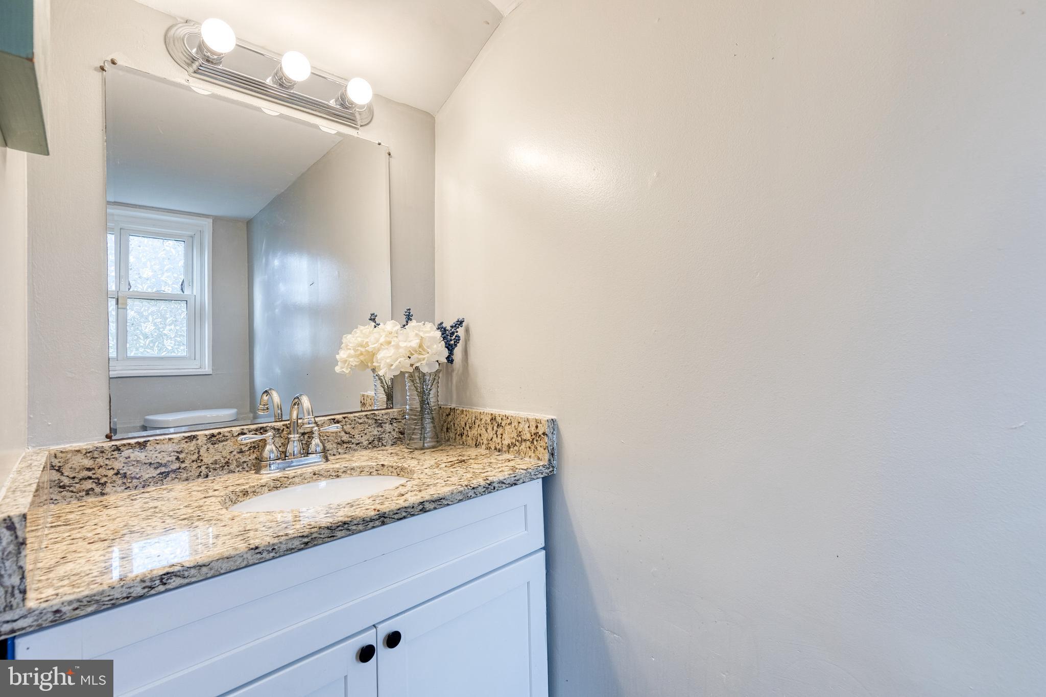 913 Marksworth Road Catonsville, MD 21228 - Photo 29 of 36 a bathroom with a granite countertop sink and a mirror