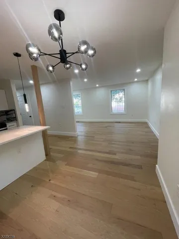 a view of a hallway with a ceiling fan and window