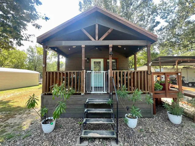 a view of a patio with table and chairs potted plants