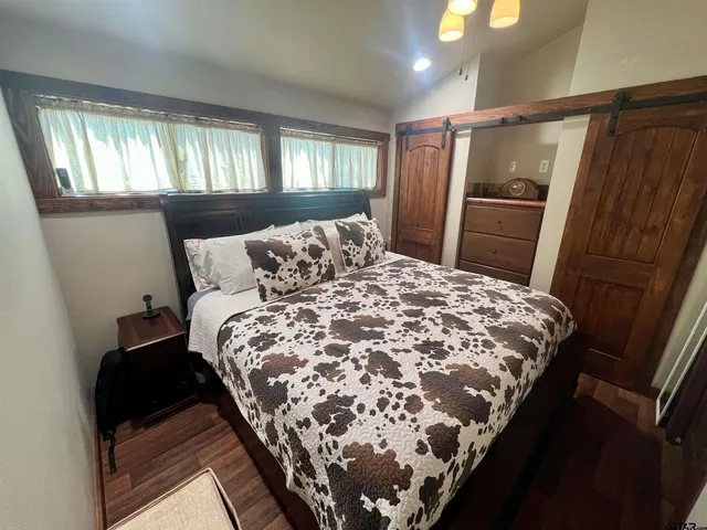 a bed sitting in a bedroom next to a window