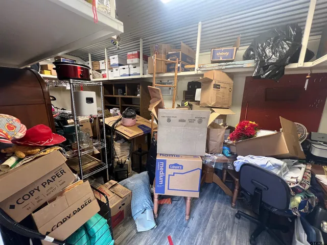 a utility room with dryer washer and a view of living room