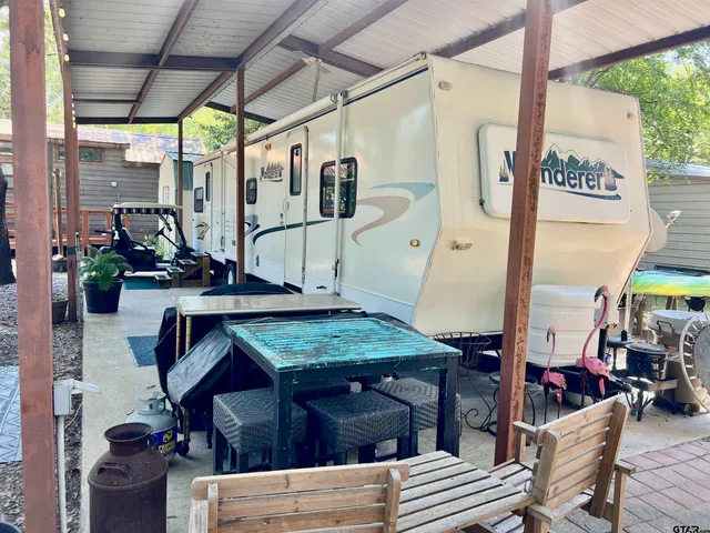 a view of a patio with table and chairs under an umbrella