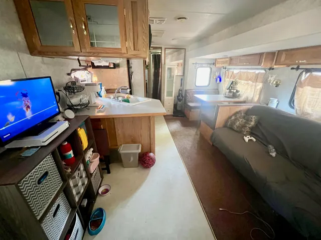 a kitchen with stainless steel appliances kitchen island granite countertop a refrigerator stove and sink