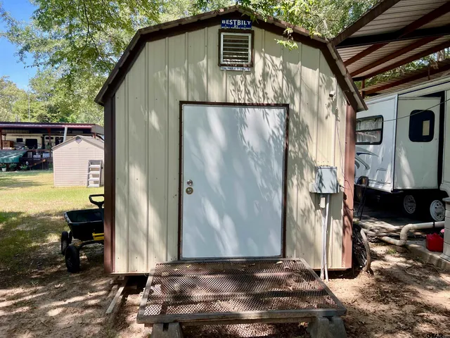 a view of walk in closet with clothes