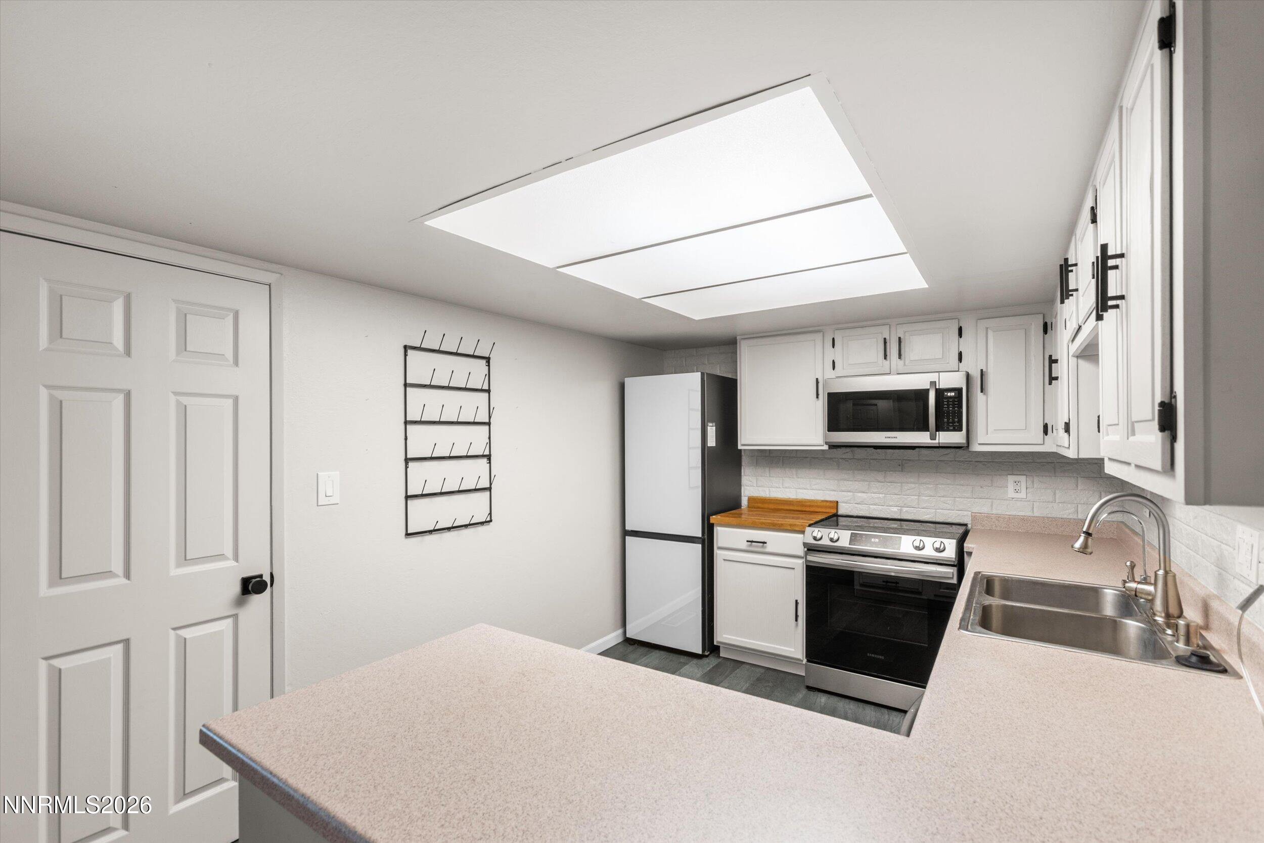 2300 Dickerson Road, Unit 51 Reno, NV 89503 - Photo 6 of 46 a kitchen with stainless steel appliances a stove a sink and a refrigerator