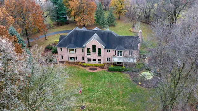 a living room with furniture a chandelier and a piano