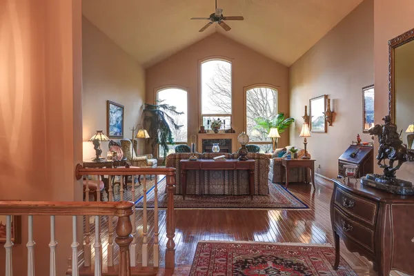 a living room with furniture a large window and a fireplace