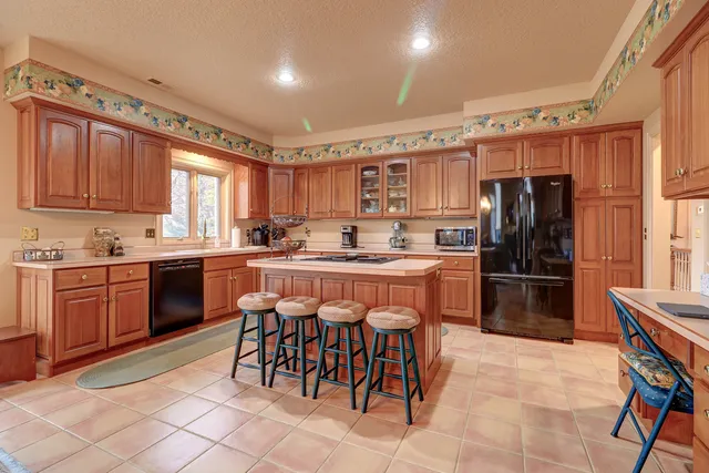 a bathroom with a granite countertop sink and a large mirror