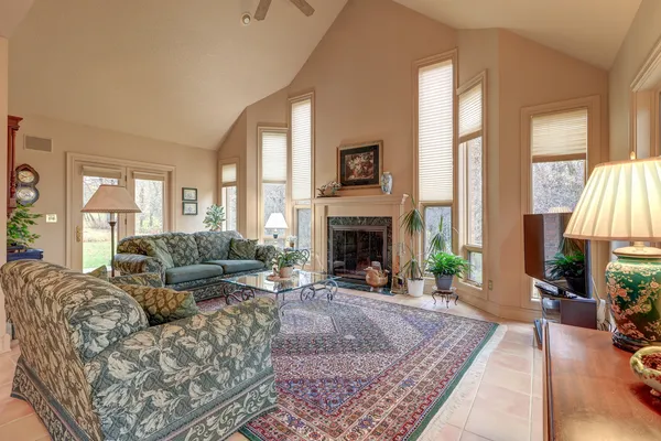 a work room with furniture and large windows