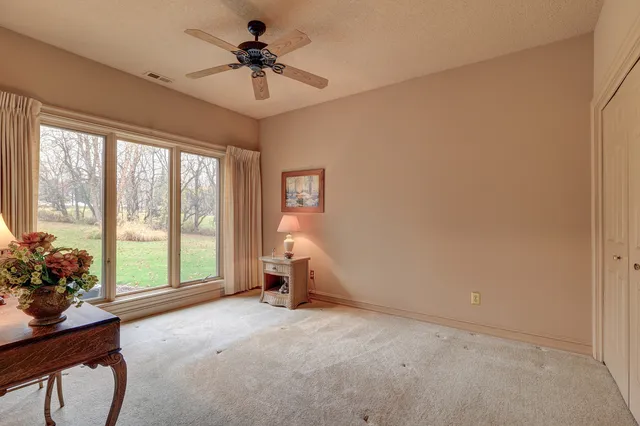 a view of a dining room with furniture and a floor to ceiling window