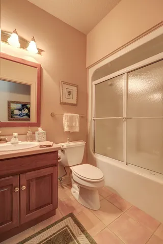 a dining room with furniture a rug and a chandelier
