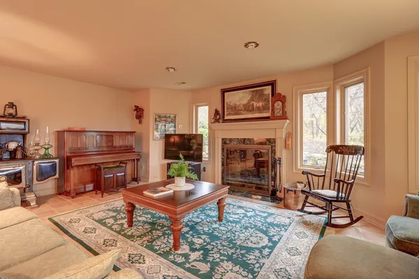 a park with large trees and a wooden fence
