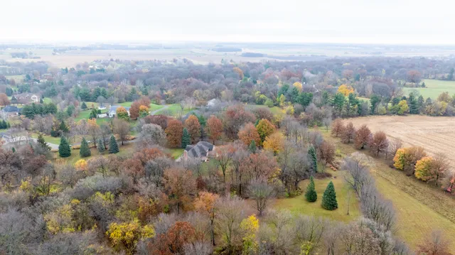 an aerial view of a house with a yard