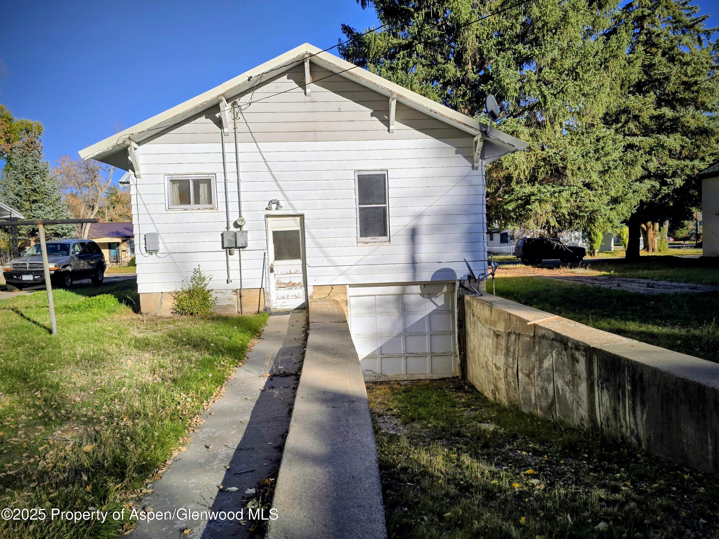 720 Barclay Street Craig, CO 81625 - Photo 5 of 22 a white house that has tree in front of it