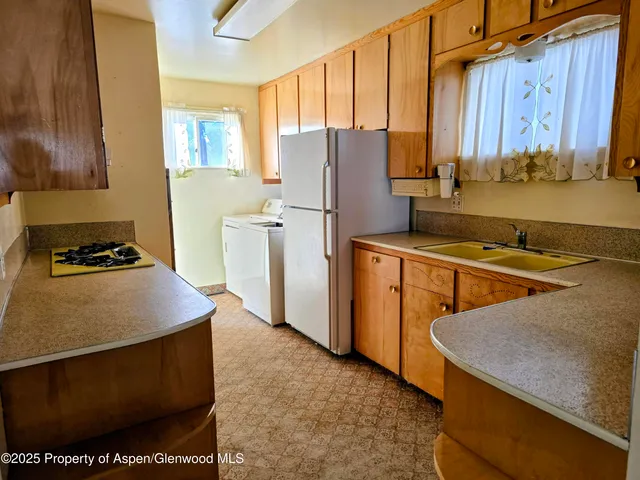 a kitchen with stainless steel appliances granite countertop a stove and a refrigerator