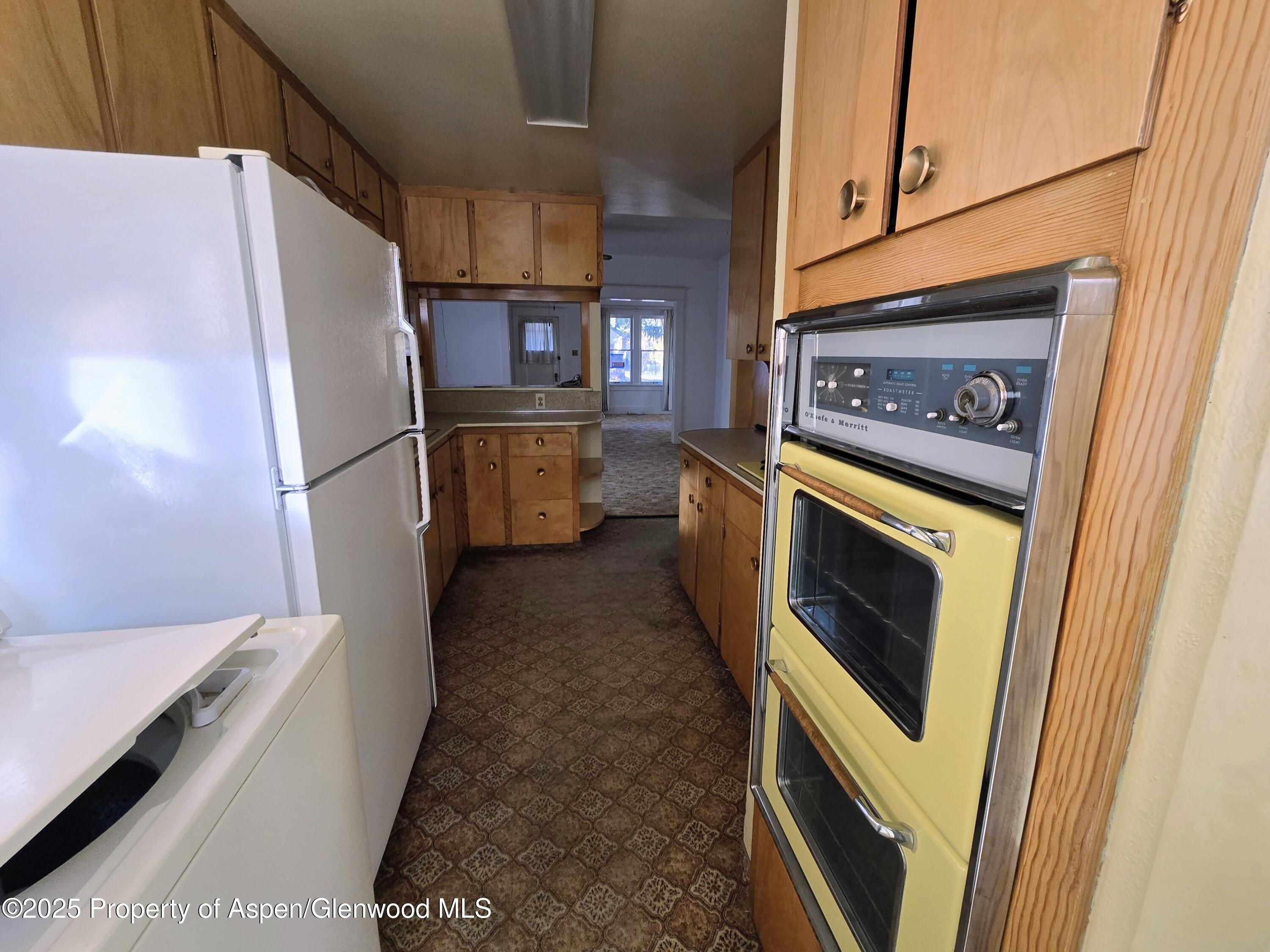 720 Barclay Street Craig, CO 81625 - Photo 9 of 22 a kitchen with stainless steel appliances granite countertop a refrigerator a washer and dryer