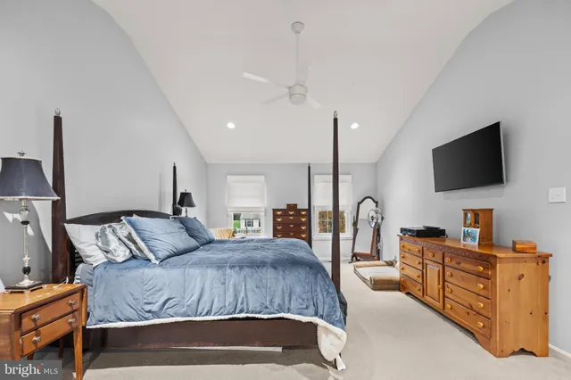 a kitchen with stainless steel appliances granite countertop a refrigerator a sink dishwasher a stove and a dining table with wooden floor