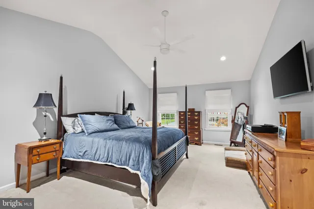 a kitchen with stainless steel appliances granite countertop a kitchen island a stove a refrigerator a oven a dining table and chairs with wooden floor