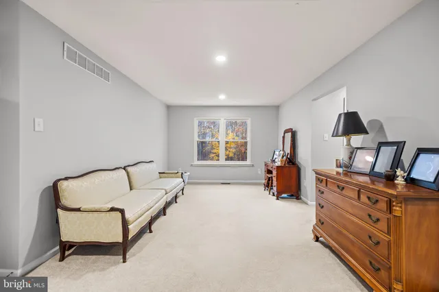 a kitchen with stainless steel appliances granite countertop a table chairs sink and wooden floor